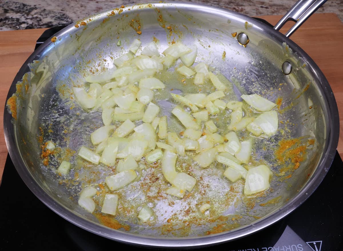 chopped onions cooking in butter in a skillet.