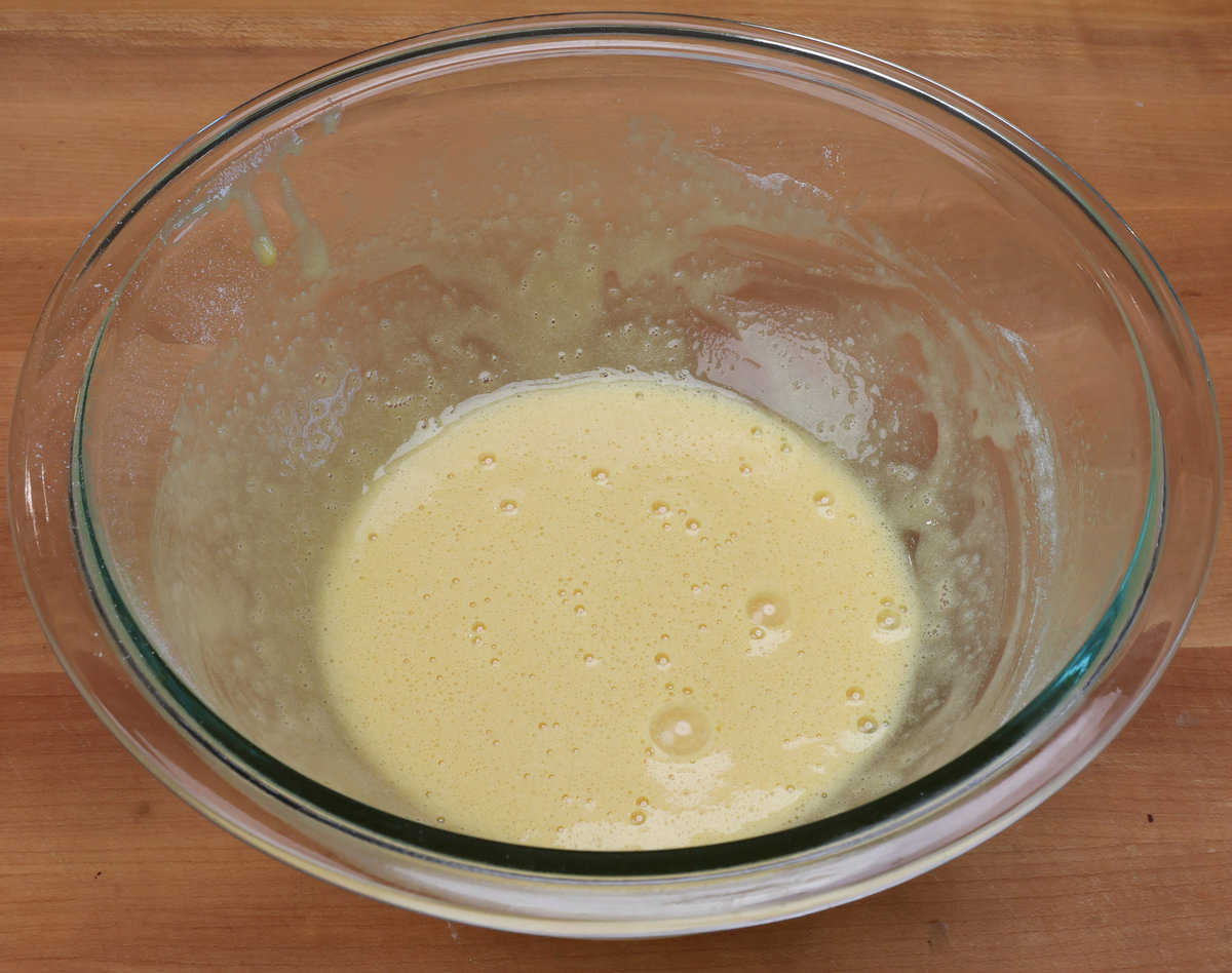 flour, egg, sugar, and vanilla whisked together in a mixing bowl.