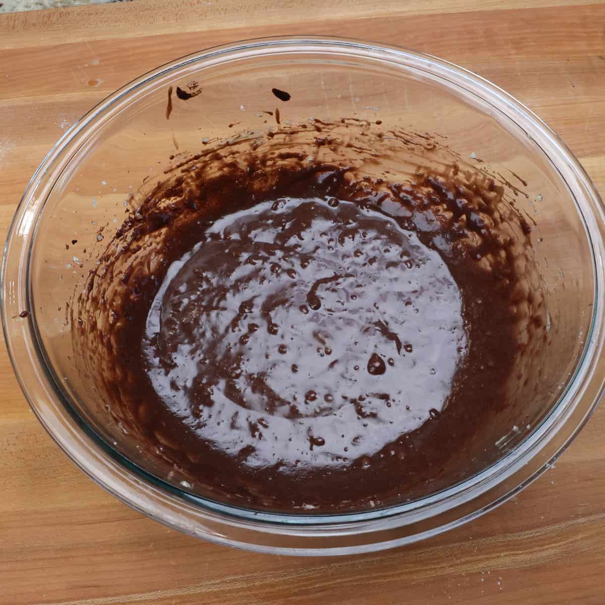german chocolate cake batter and coffee whisked together in a small mixing bowl.