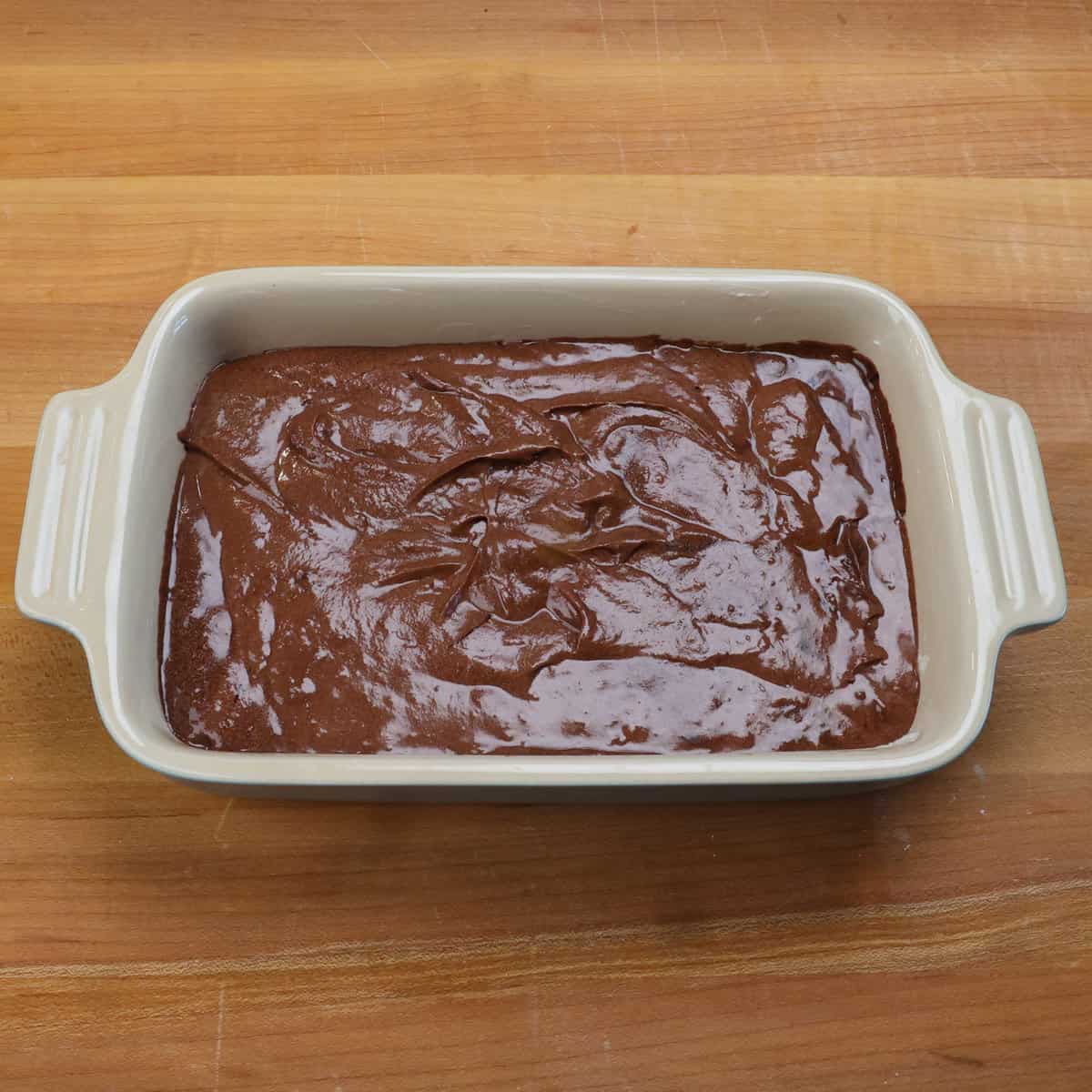 German chocolate cake batter in a small rectangular baking dish.