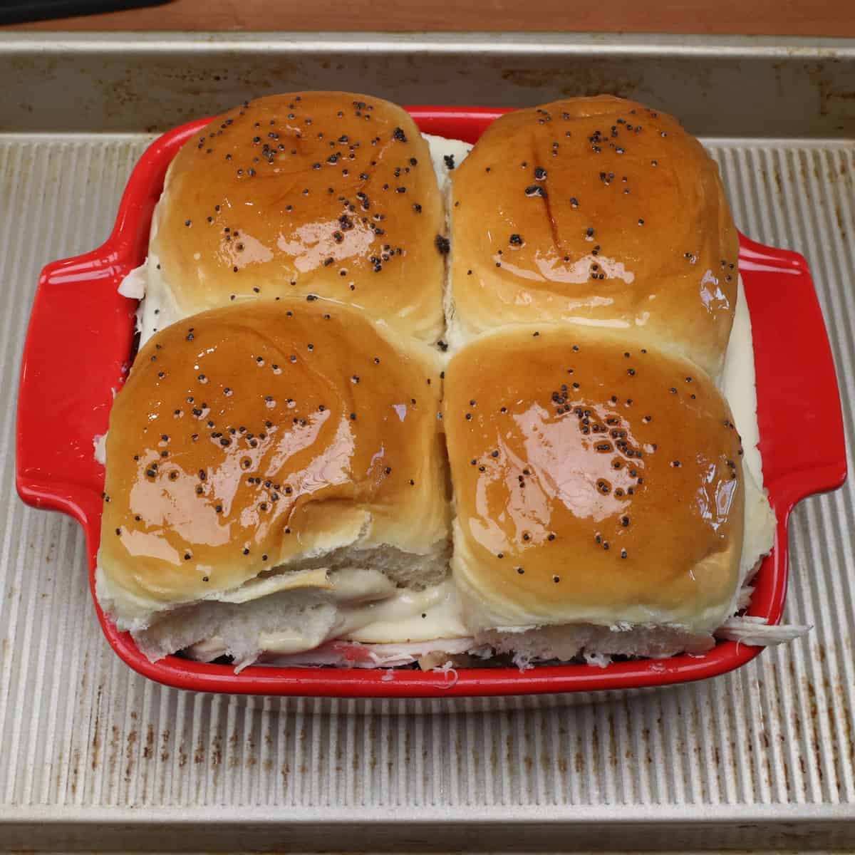 melted butter and poppy seeds brushed over the tops of four leftover thanksgiving sliders.