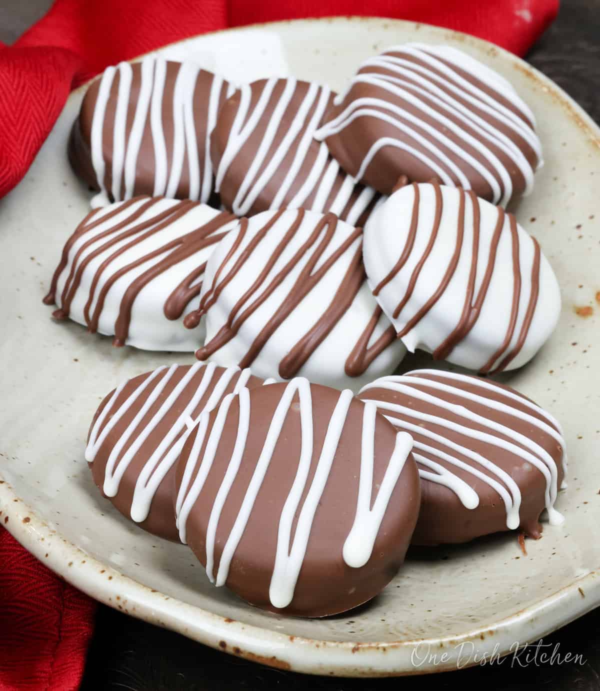 white and dark chocolate covered oreos on a plate.