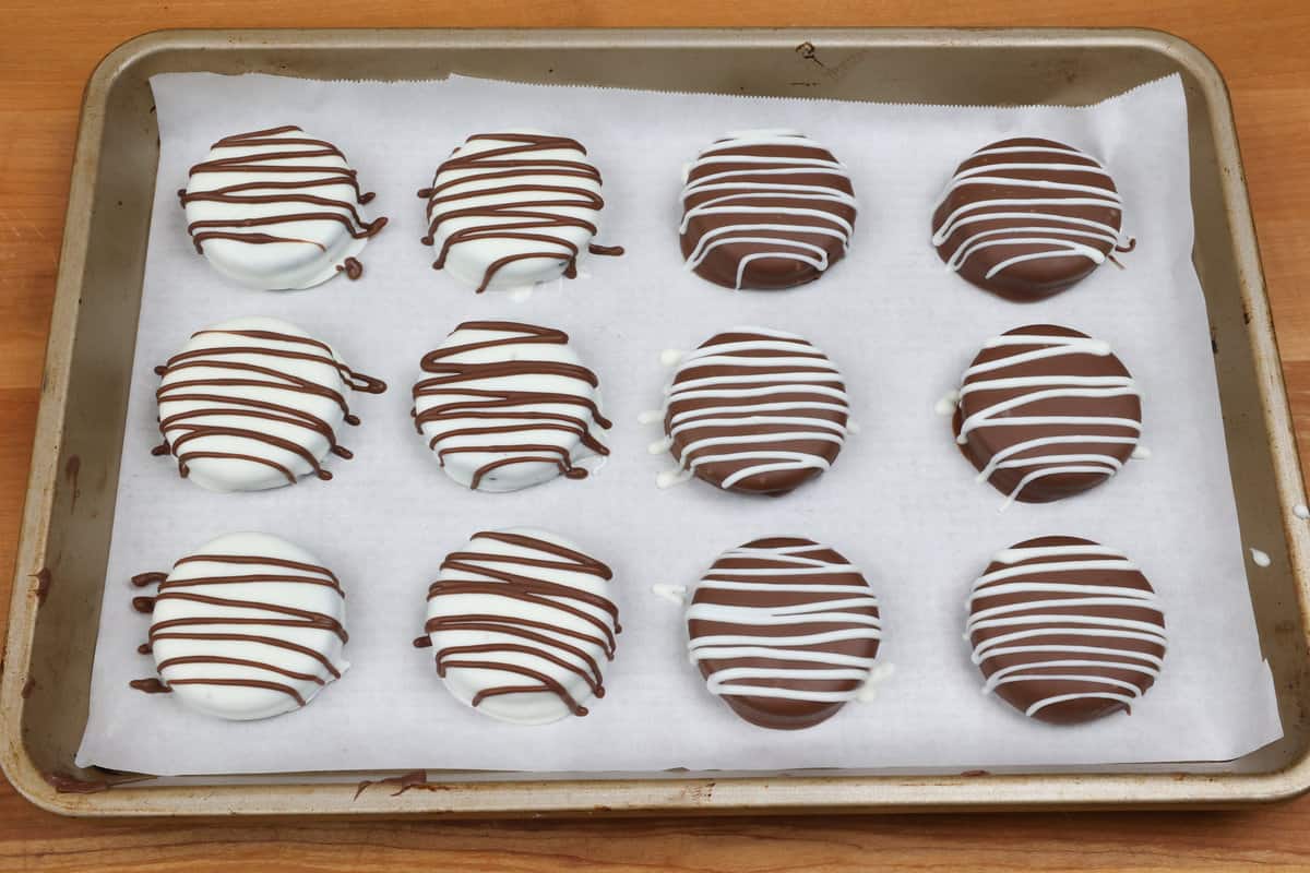 chocolate covered oreos on a baking sheet.