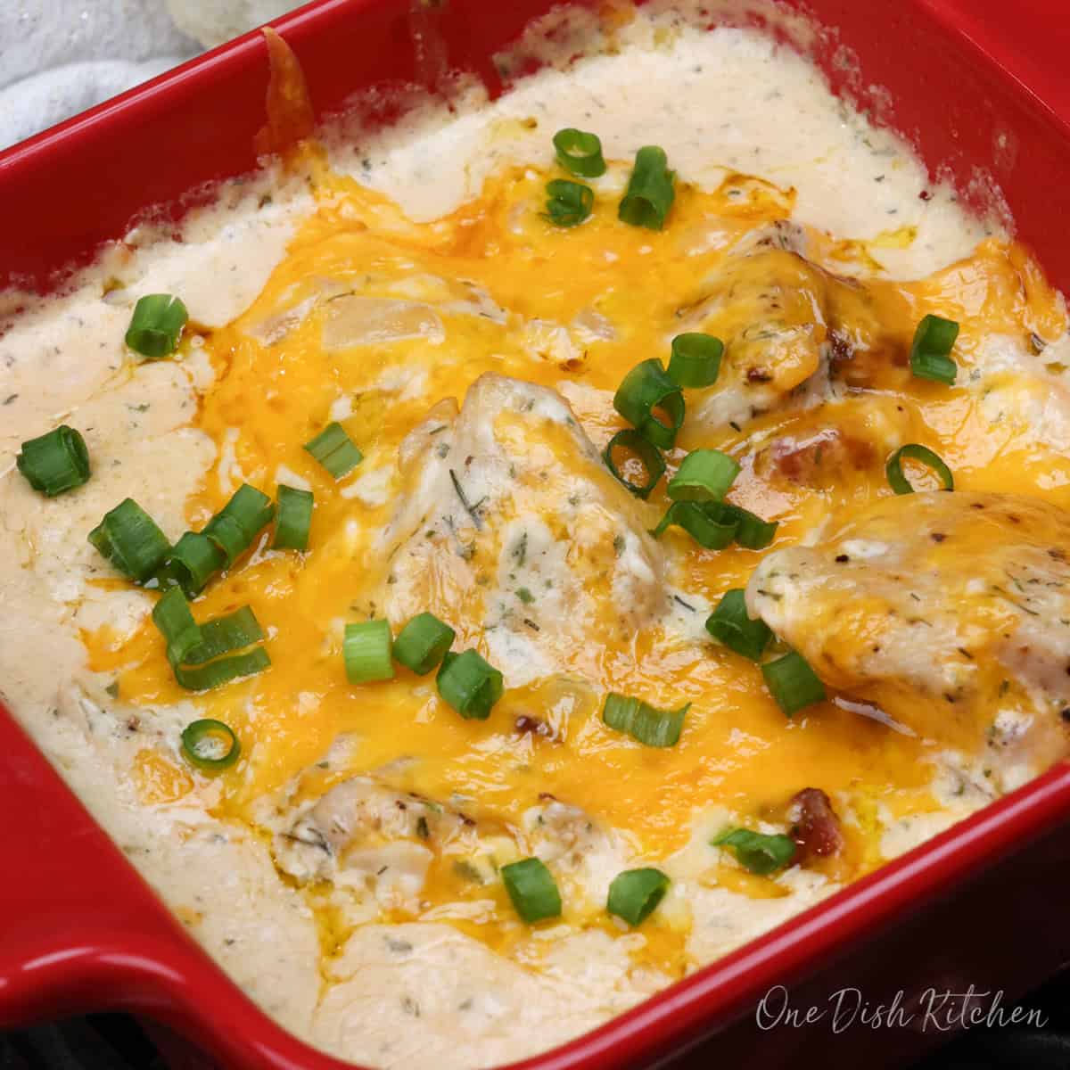 a small serving of crack chicken in a red baking dish.