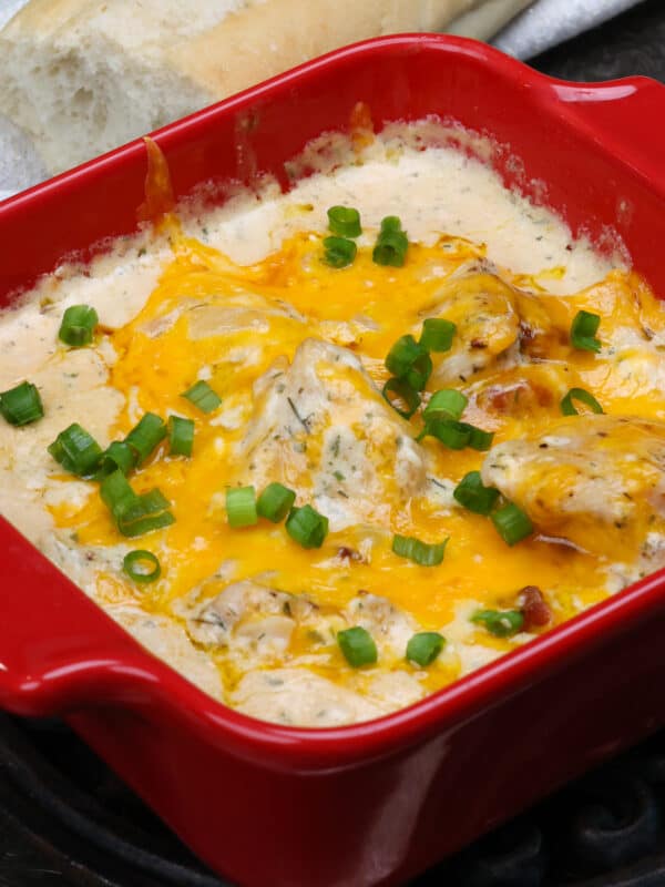 a small batch of crack chicken topped with melted cheese and chopped green onions.