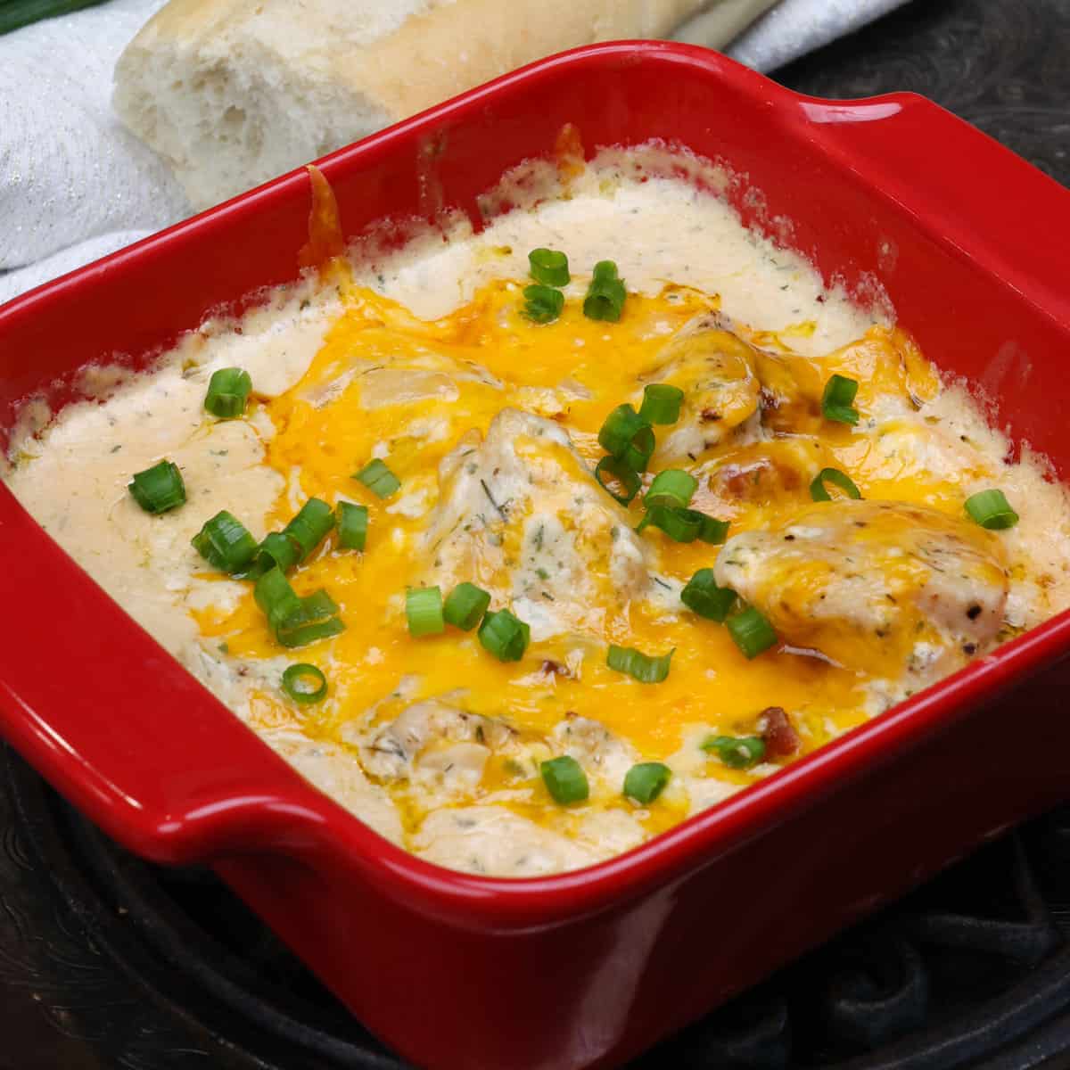 a small batch of crack chicken topped with melted cheese and chopped green onions.