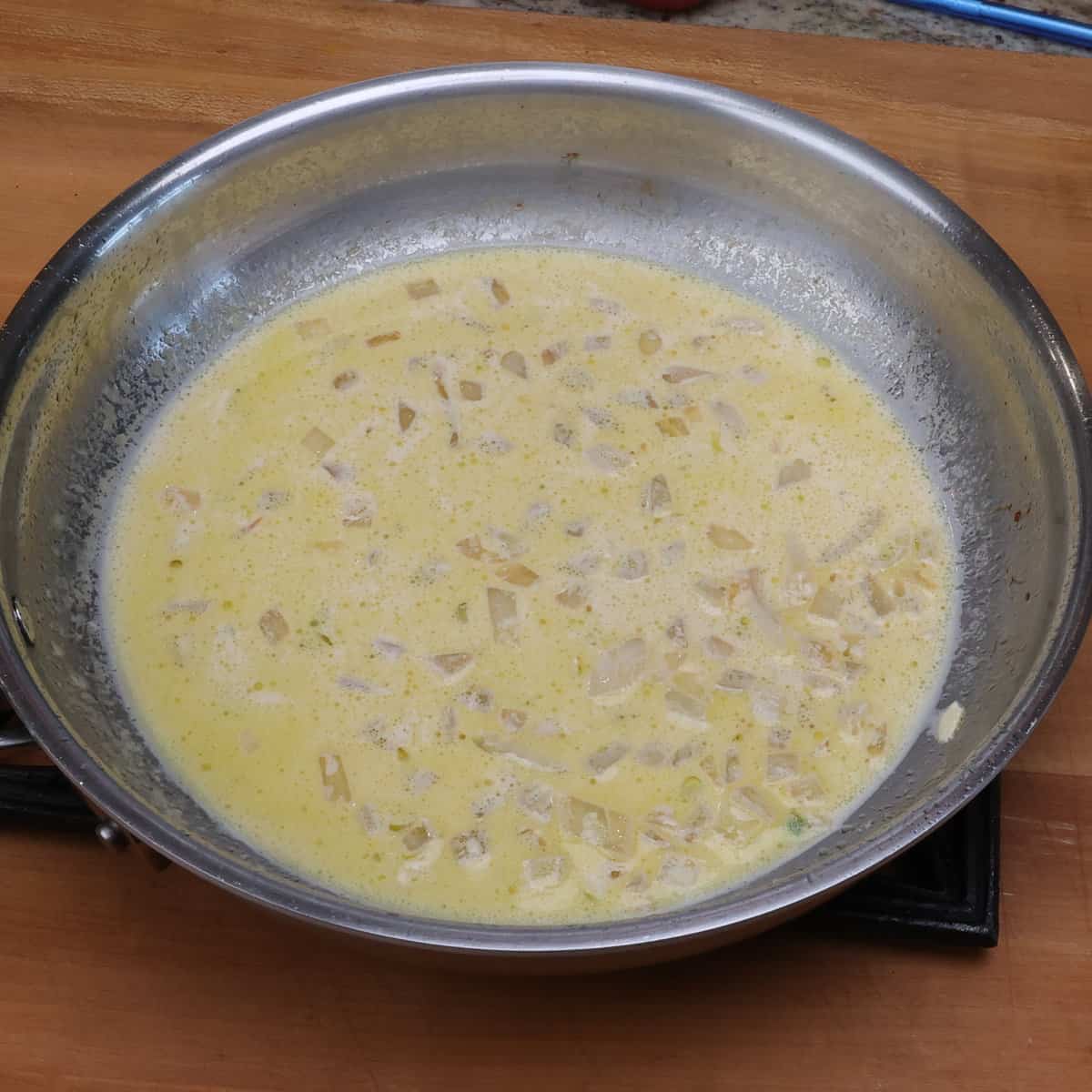 a crack chicken cream sauce simmering on the stove.