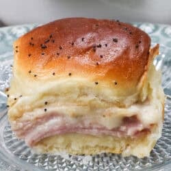 a ham and cheese slider on a plate.