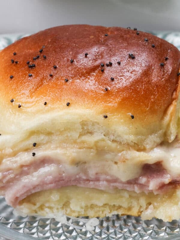 a ham and cheese slider on a plate.