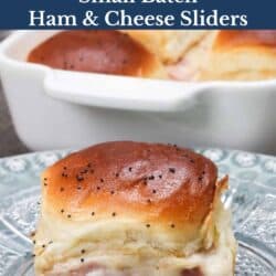 four ham and cheese sliders on a table.