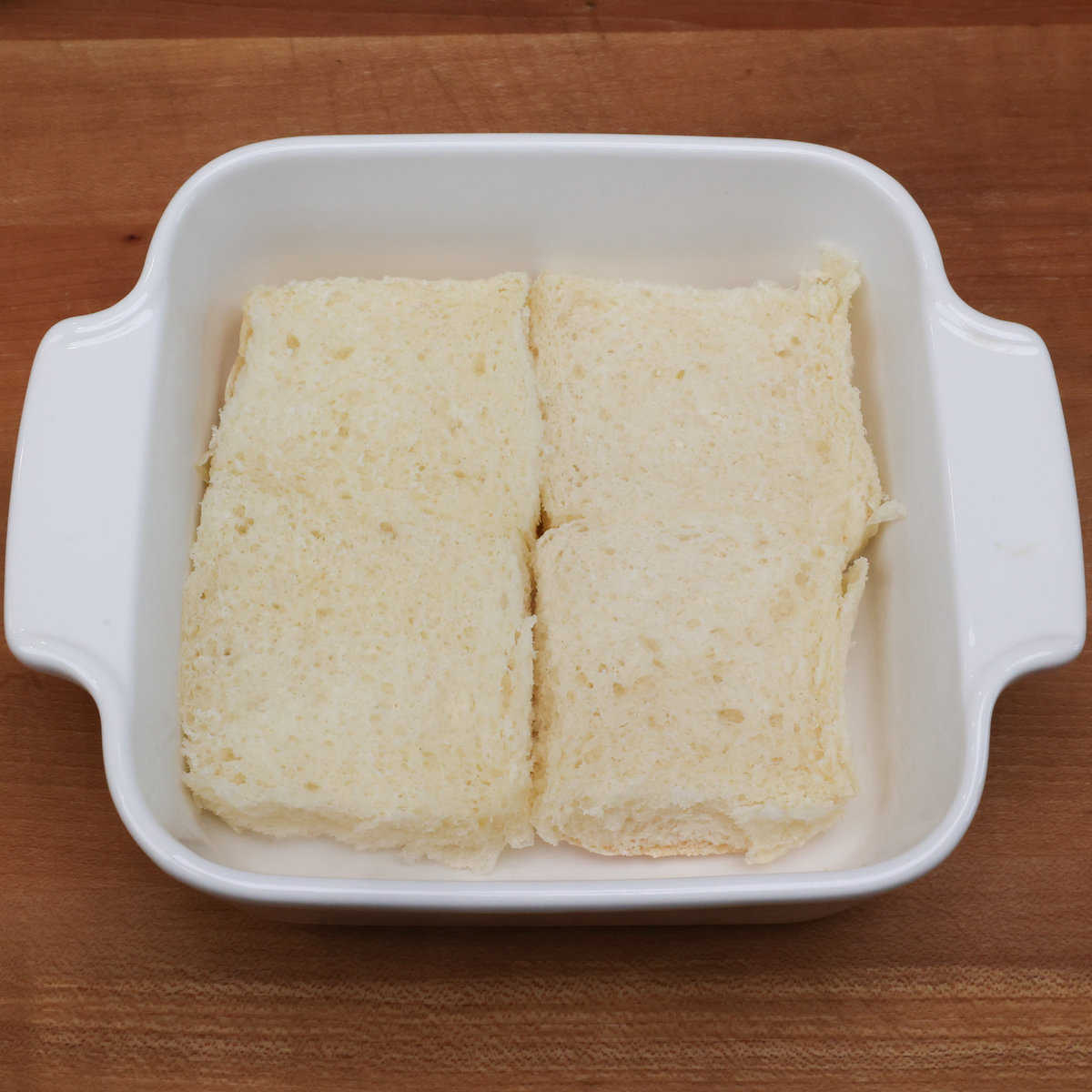 four Hawaiian rolls bottoms in a small baking dish.