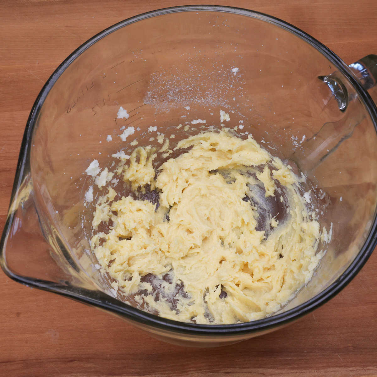 creamed butter, sugar, an egg yolk, and vanilla in a mixing bowl. 