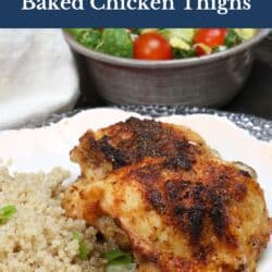 two baked chicken thighs on a white plate next to a side of cooked quinoa.