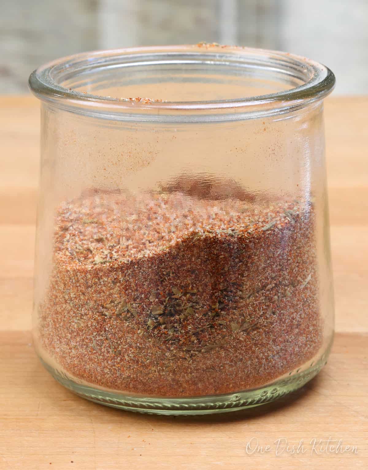 a small batch of creole seasoning in a jar on a kitchen counter.