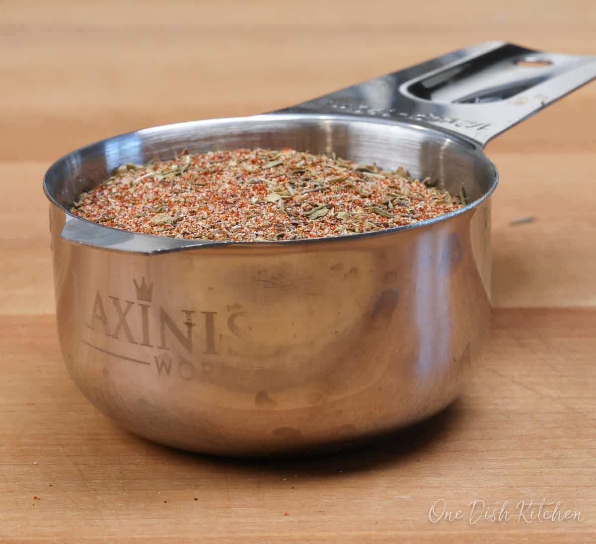 Creole seasoning in a small measuring cup.