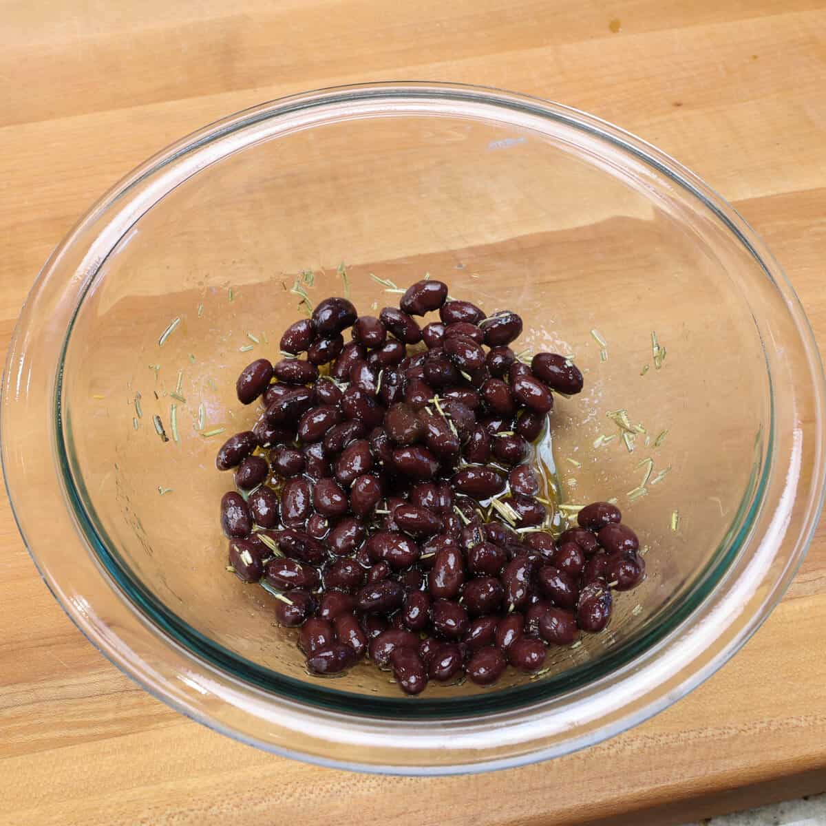 black beans tossed with a vinaigrette in a small bowl.