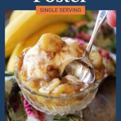 Bananas Foster with bananas on top of ice cream in a glass dessert bowl.