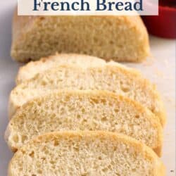 Slices of french bread on a cutting board.