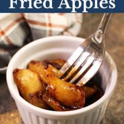 ramekin with slices of fried apples in it with a fork.