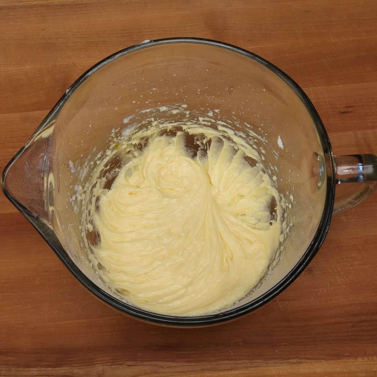 butter, egg, sugar and extracts mixed together in a mixing bowl.
