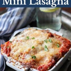 Baked lasagna in a small white baking dish.
