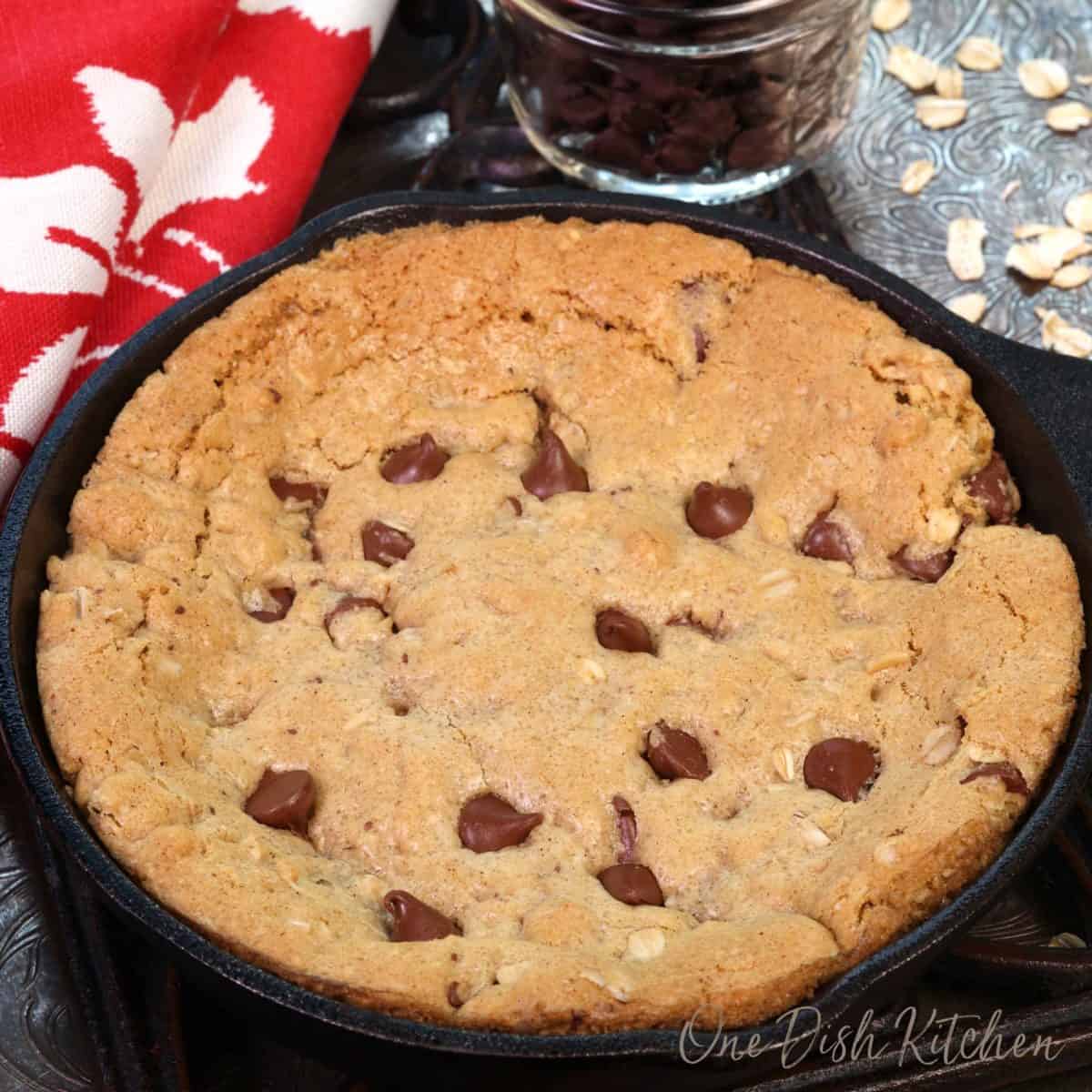 a giant chocolate chip cookie in a small cast iron skillet.