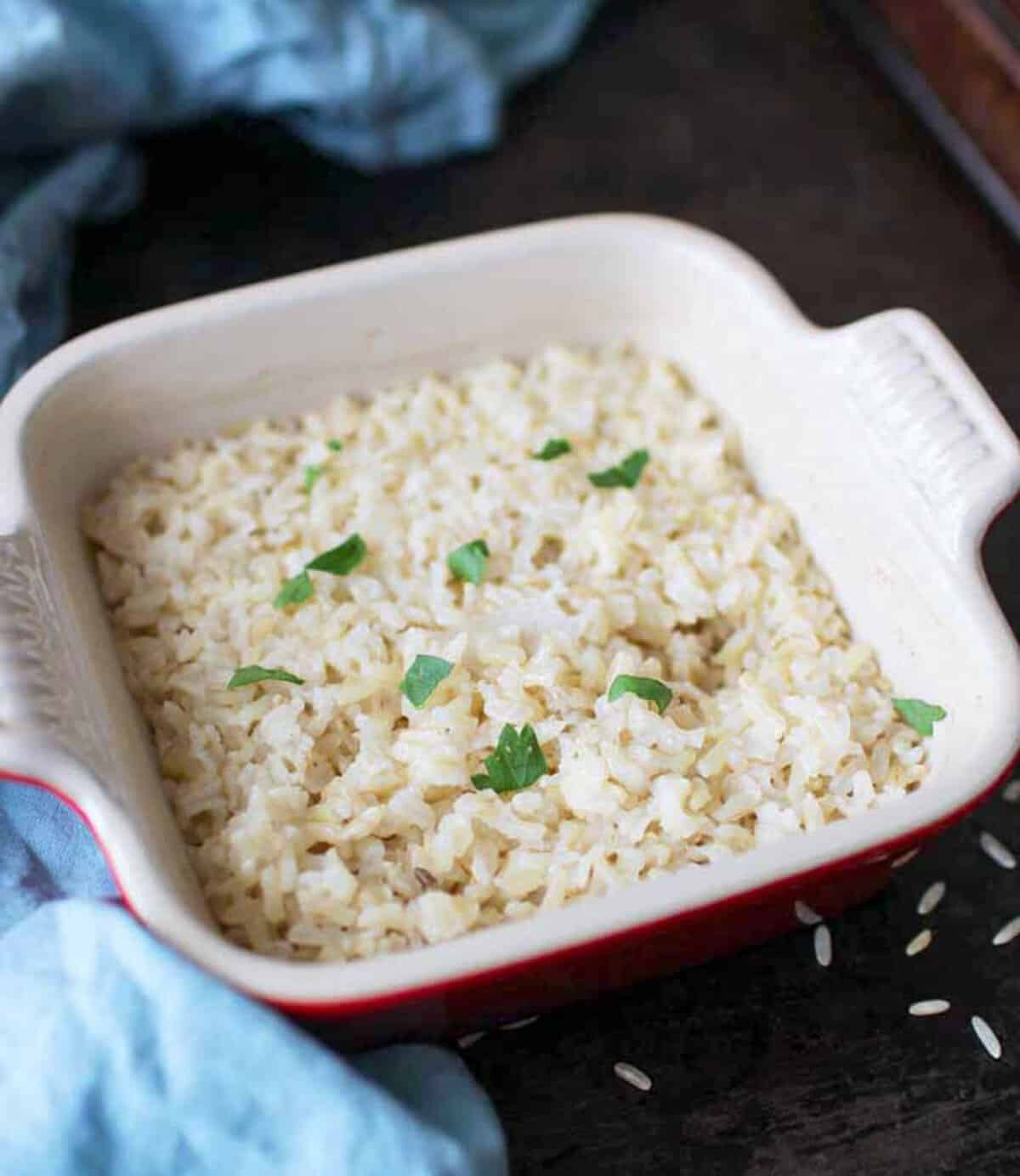 baked brown rice in a red baking dish.