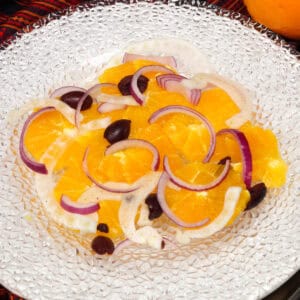 an orange and fennel salad on a white plate.