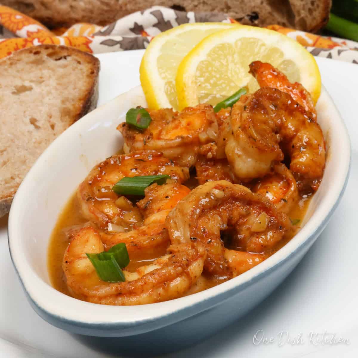 a single serving of bbq shrimp in a white bowl.