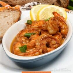 a bowl of barbecue shrimp topped with sliced green onions.