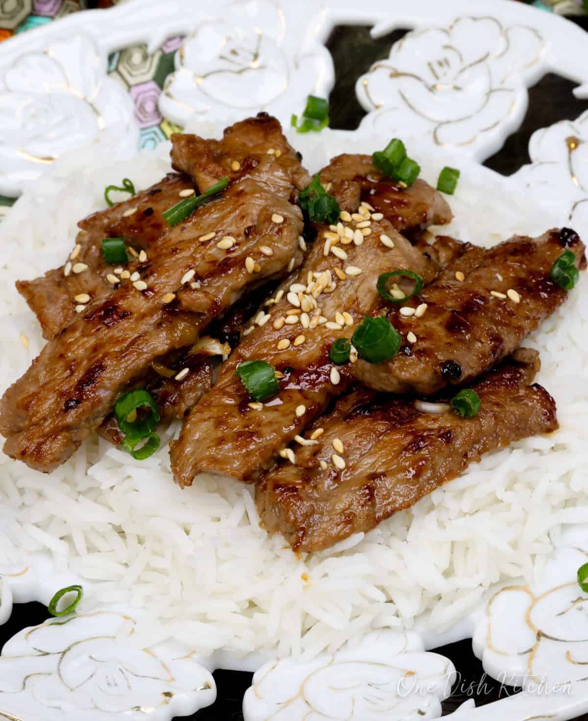 beef bulgogi over rice on a white plate.