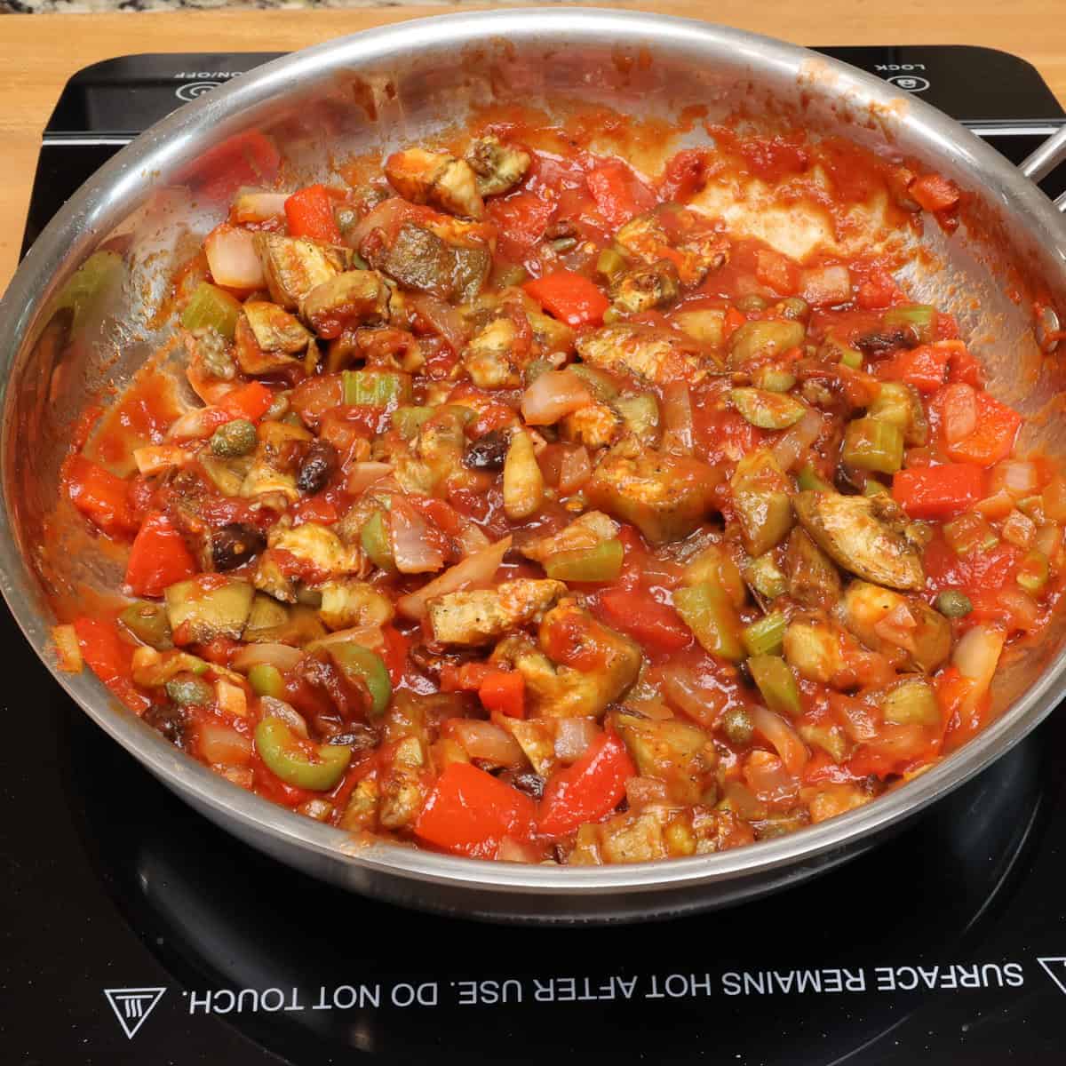 caponata simmering in a pan.