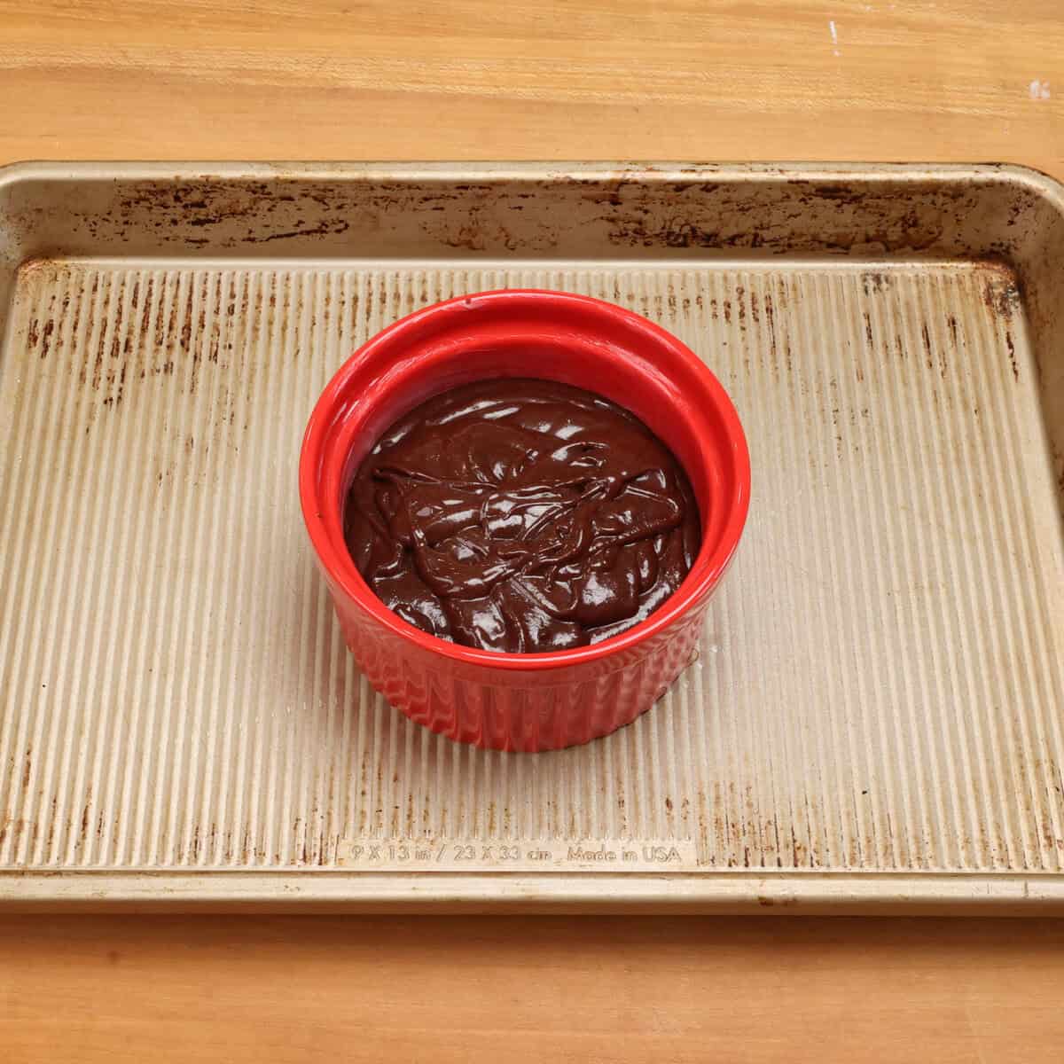 chocolate cake batter in a small red ramekin.