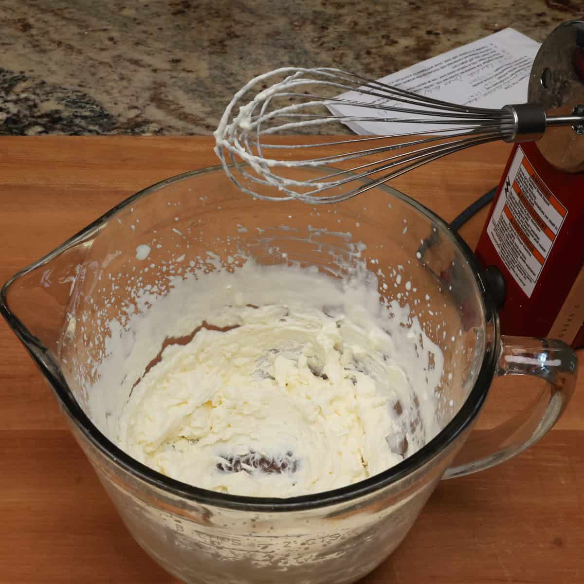 a mixing bowl filled with whipped cream.