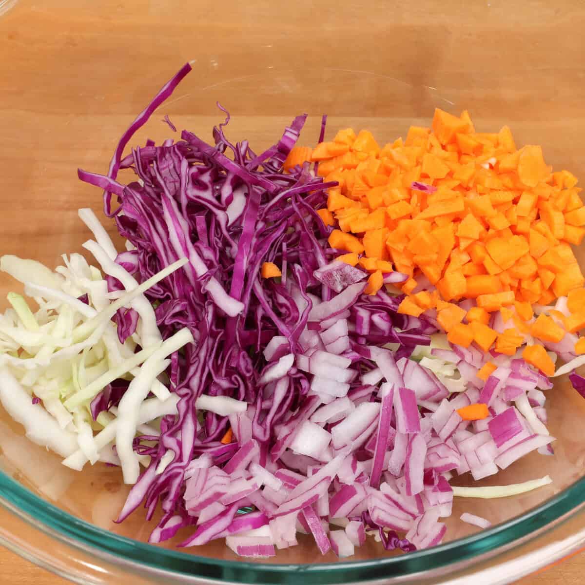 cabbage, carrots, onions in a large bowl.