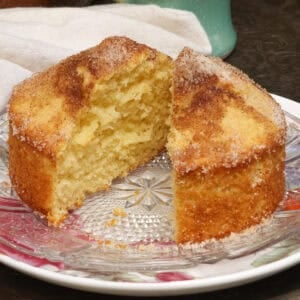 a french breakfast puff sliced in half on a plate.