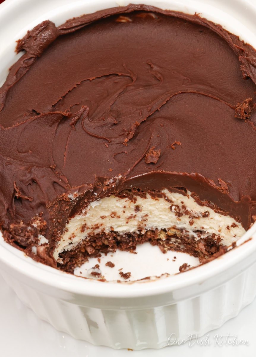 a partially eaten nanaimo bar in a ramekin.