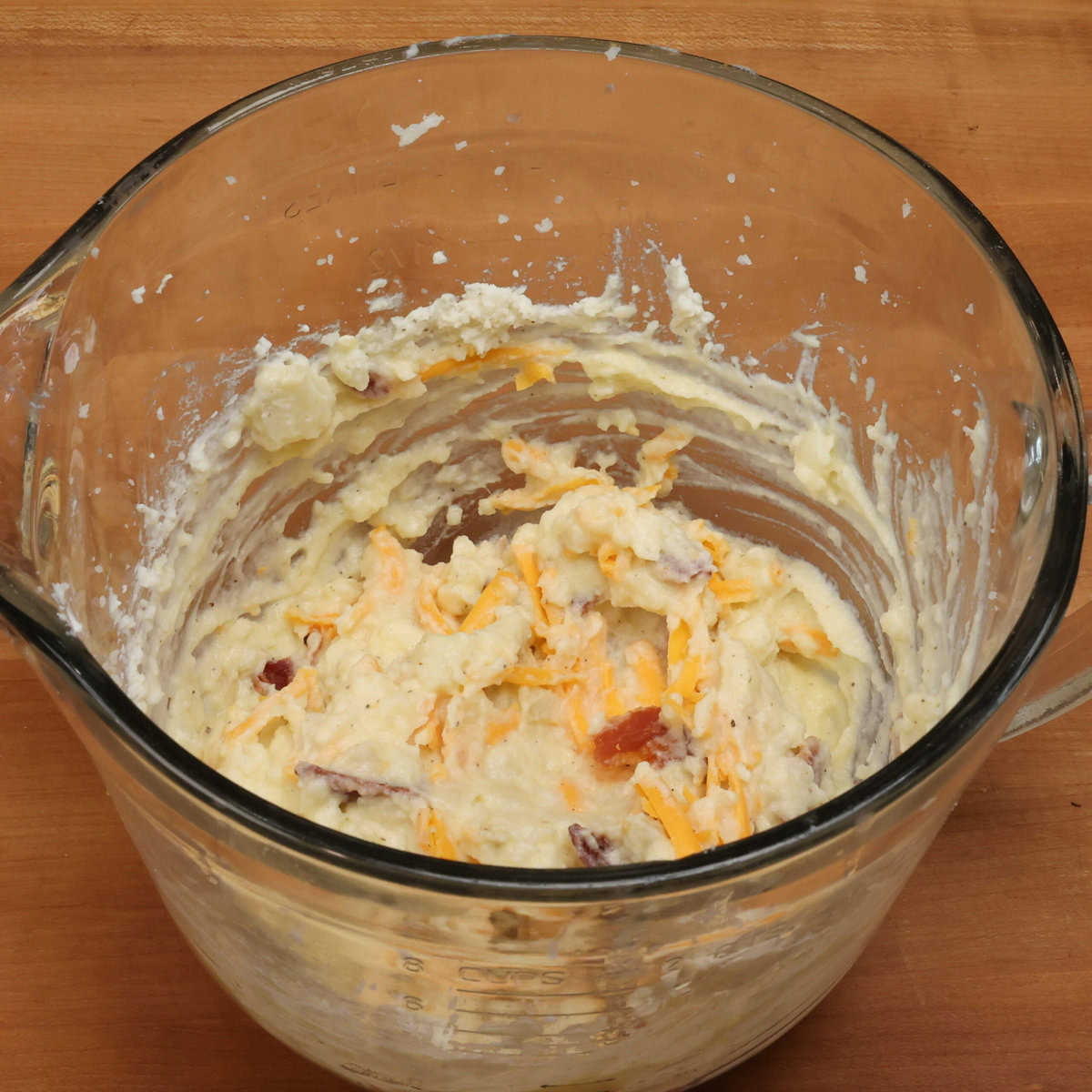 twice baked potato casserole filling in a mixing bowl.