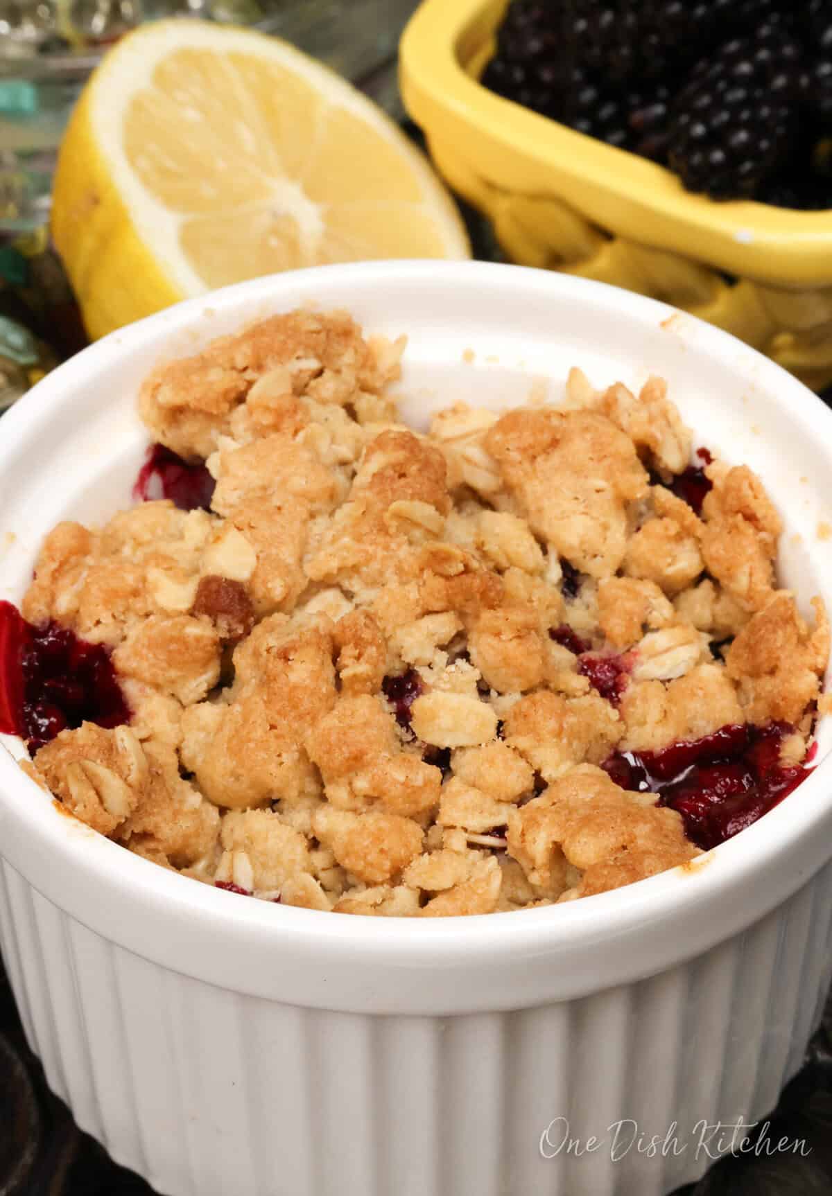 a blackberry crisp in a white ramekin.