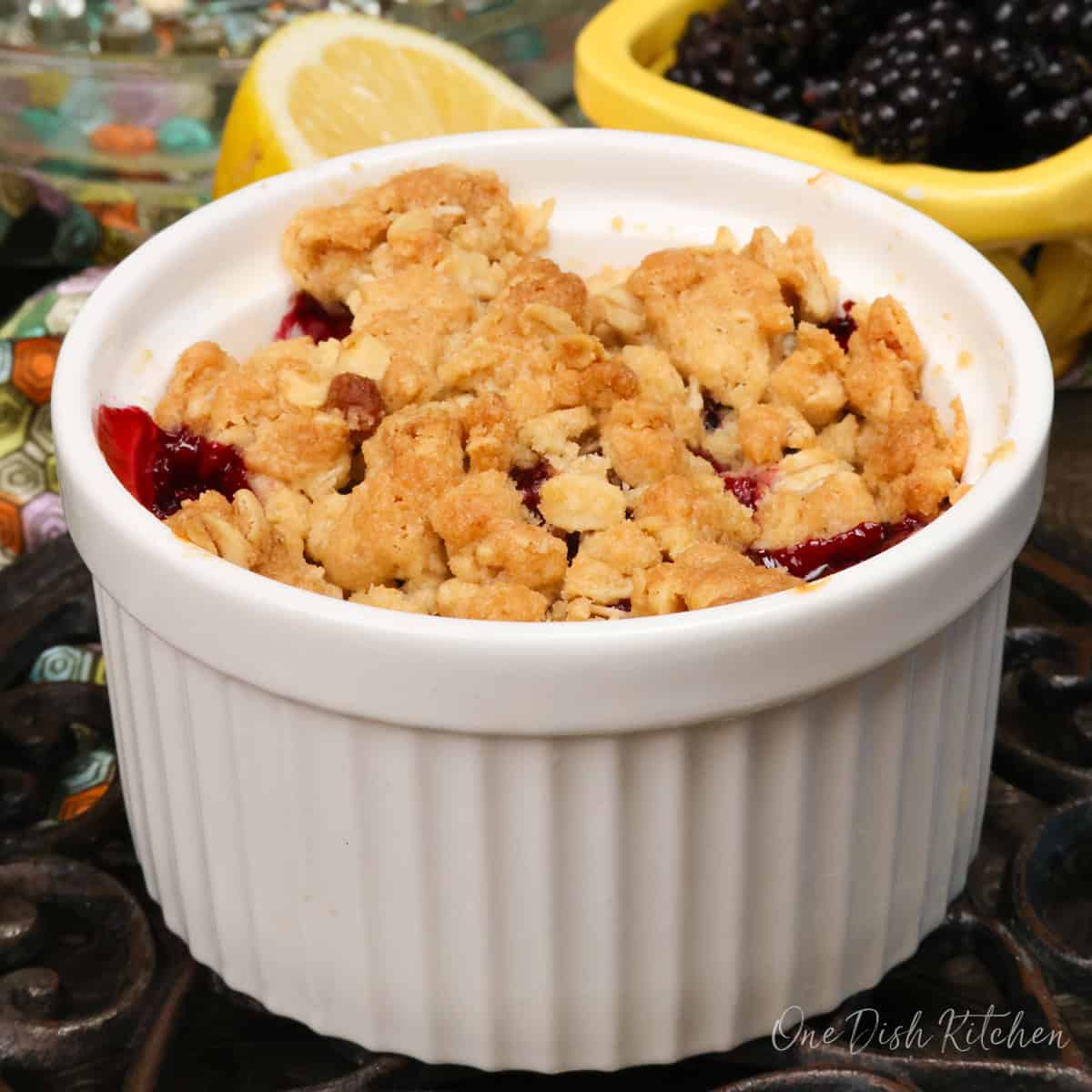 a small blackberry crisp with oat topping on a cooling rack.