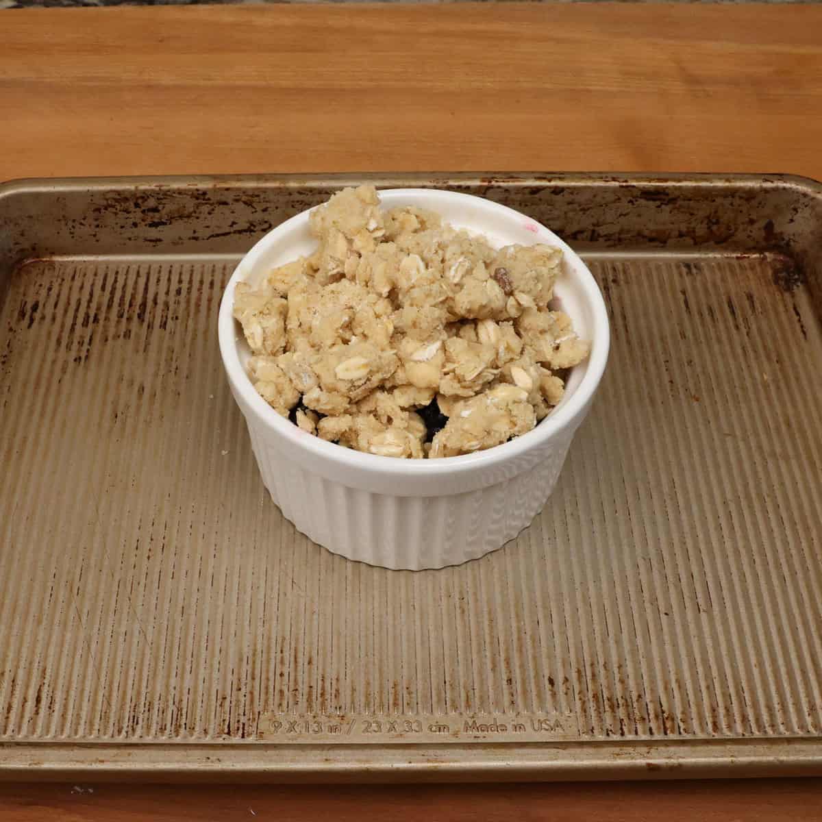 unbaked blackberry crisp on a baking sheet.