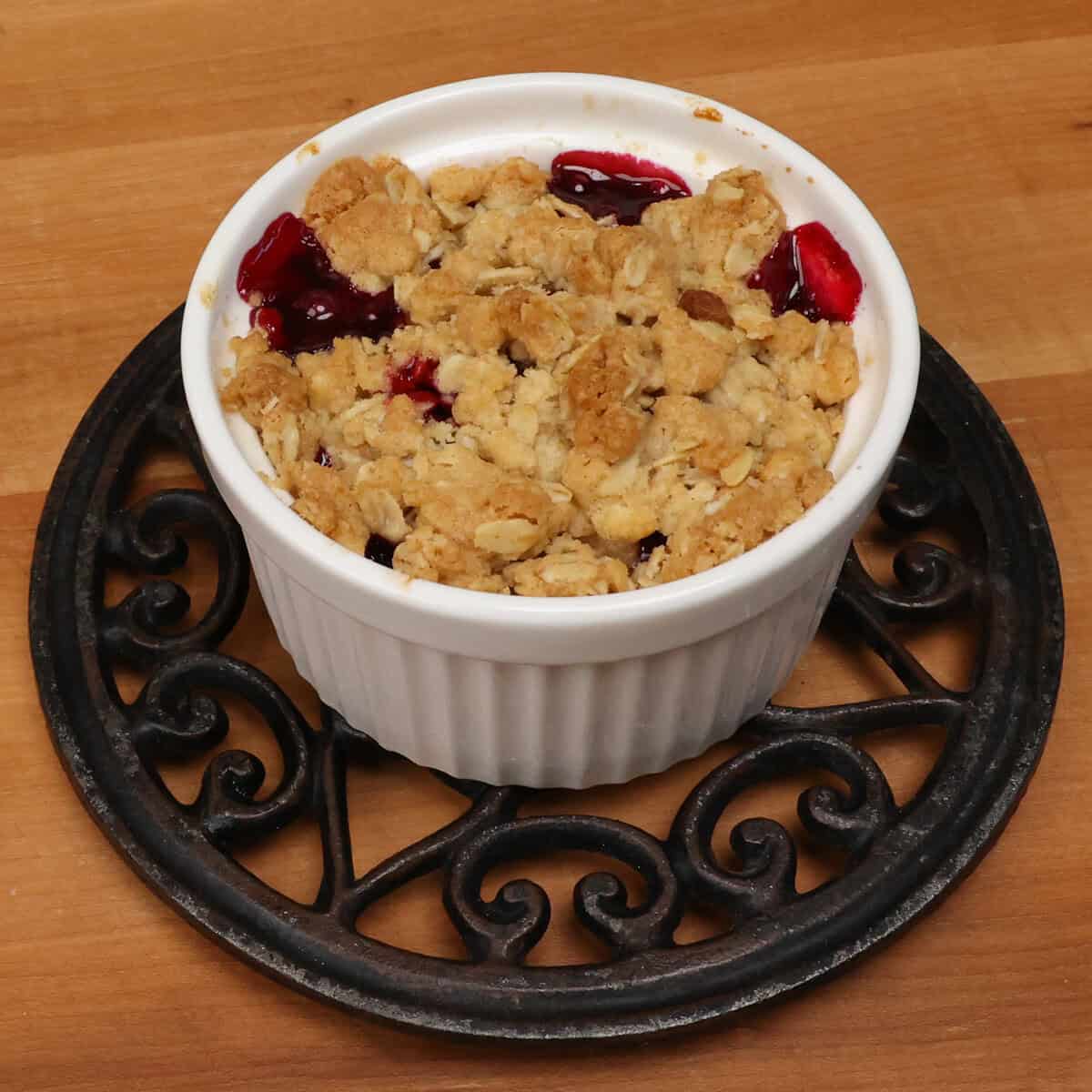 a small blackberry crisp cooling on a rack.