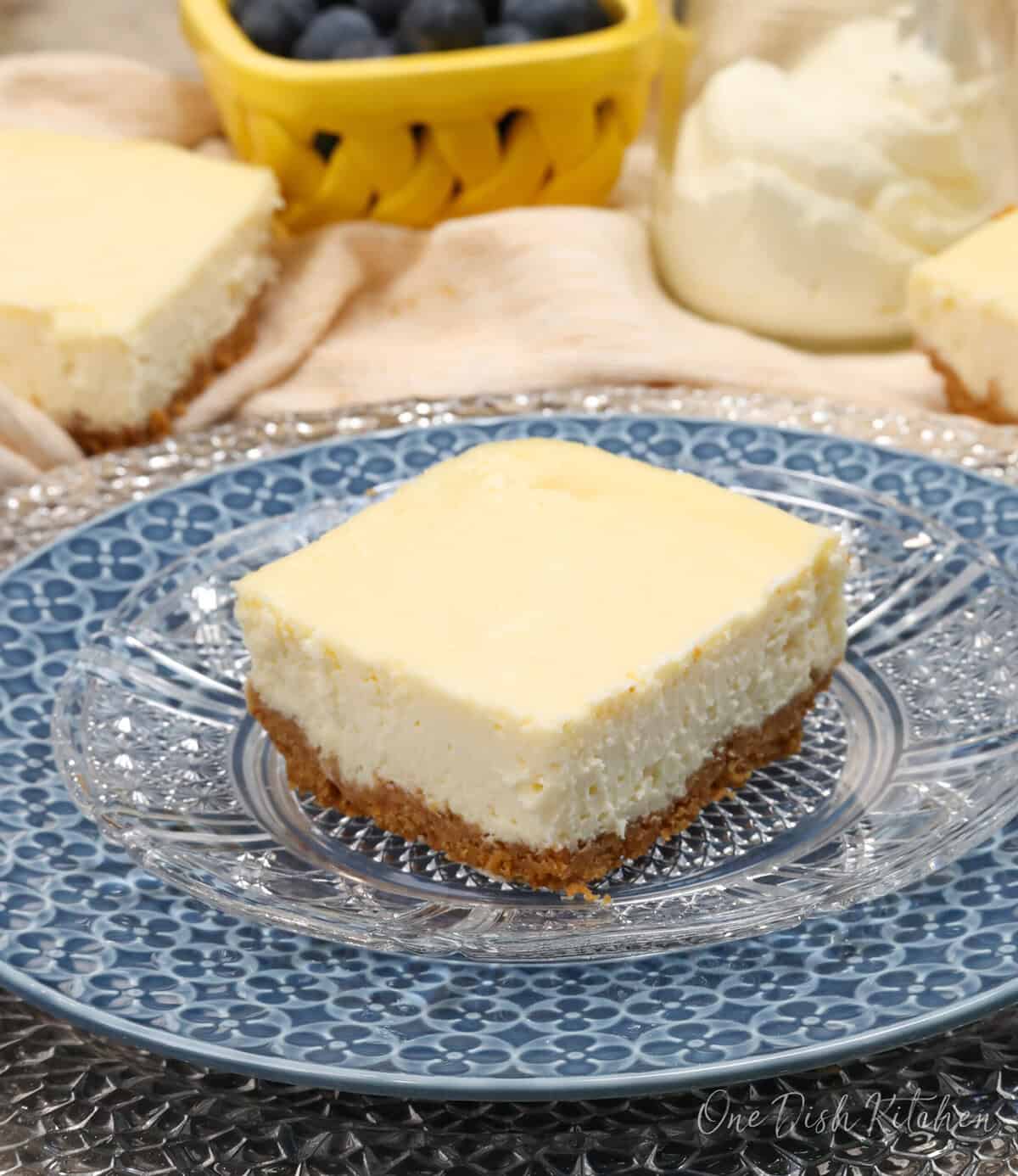 a few cheesecake bars on a table.