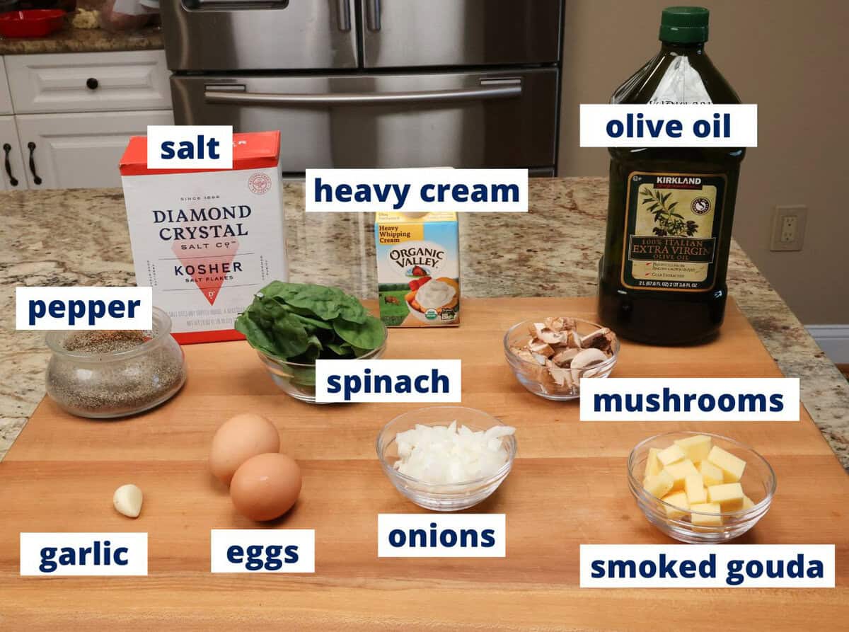 spinach mushroom quiche ingredients on a kitchen counter.