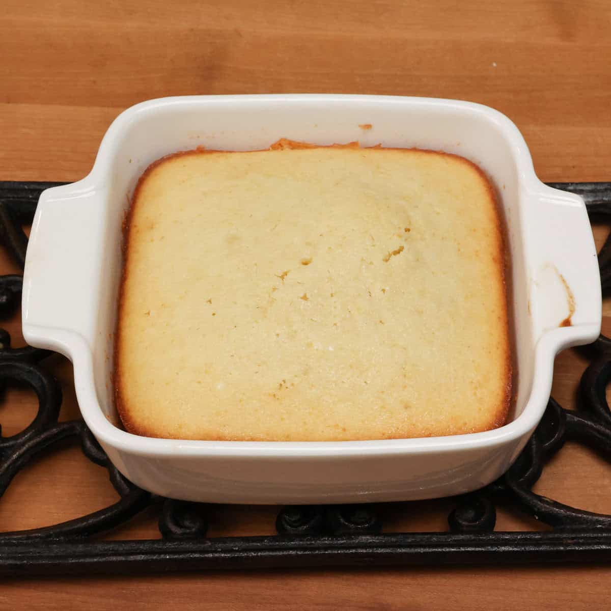 a small lemon cake in a baking dish.