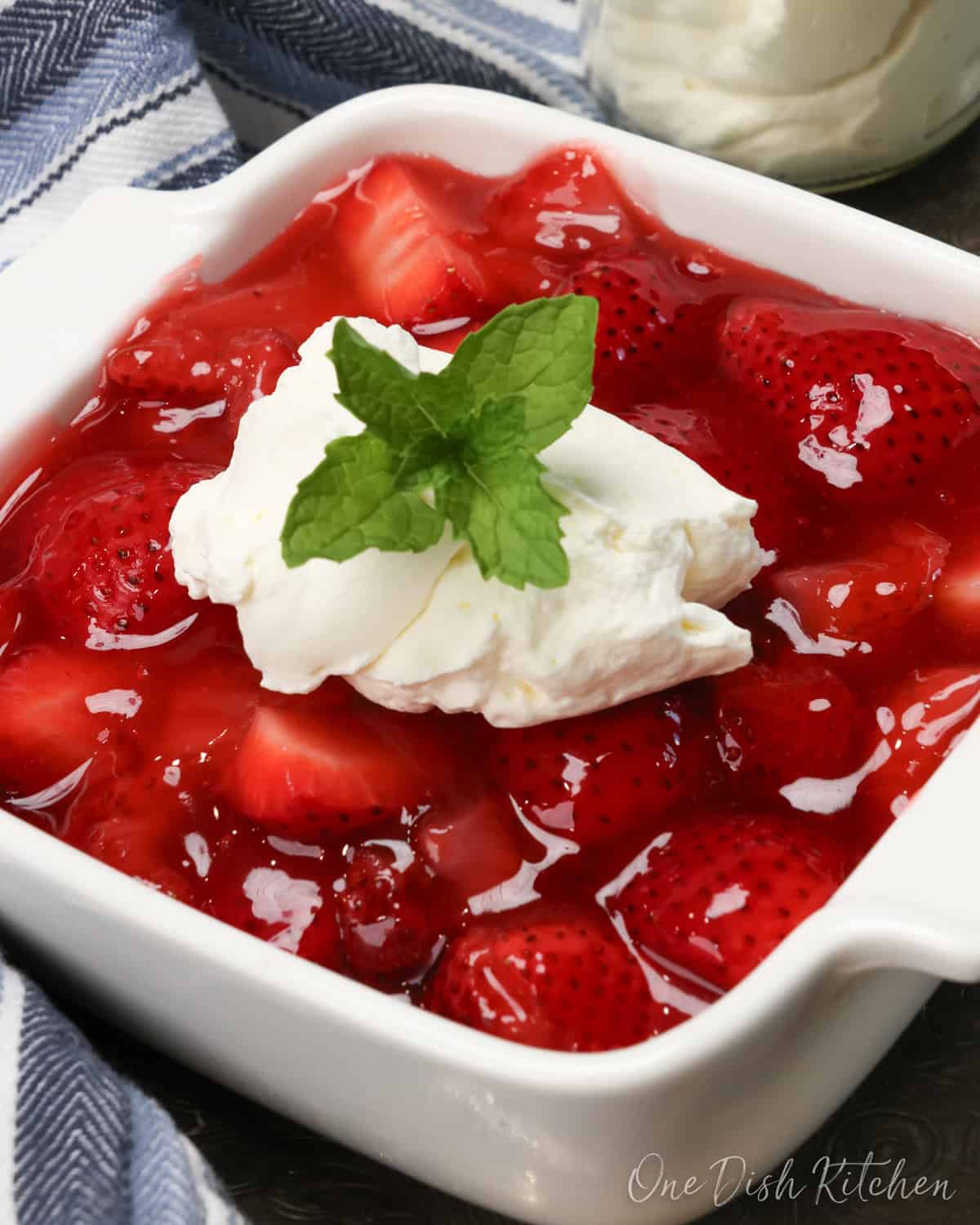 a small strawberry pie topped with whipped cream.