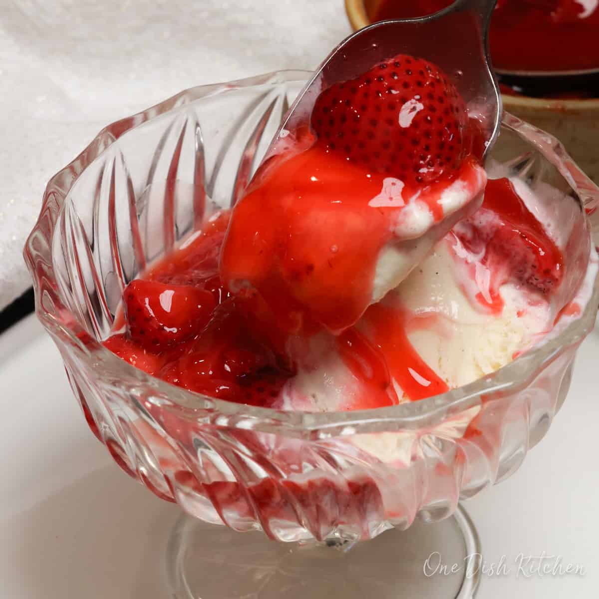 strawberry pie filling over a scoop of vanilla ice cream.