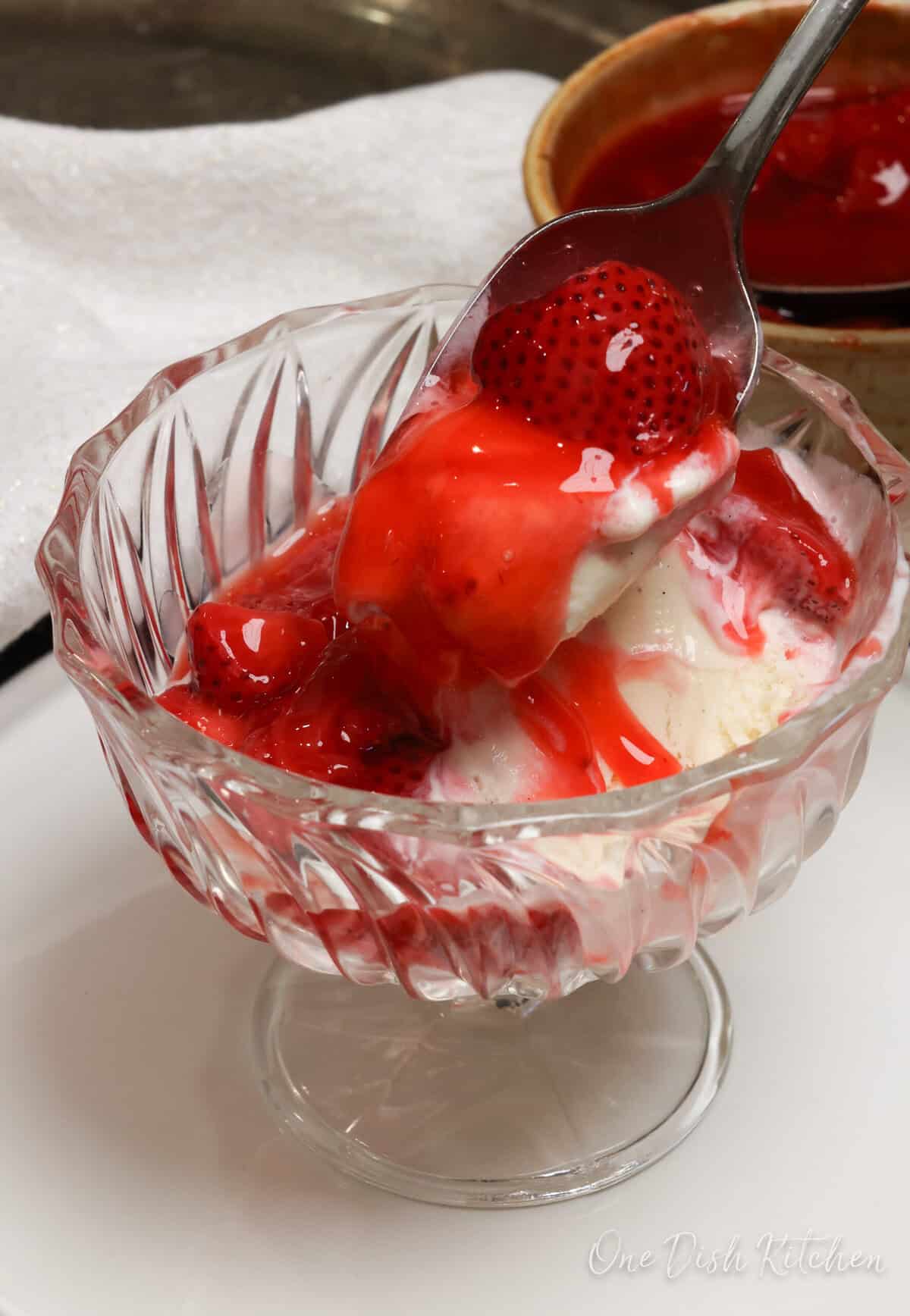 strawberry pie filling over a scoop of vanilla ice cream.