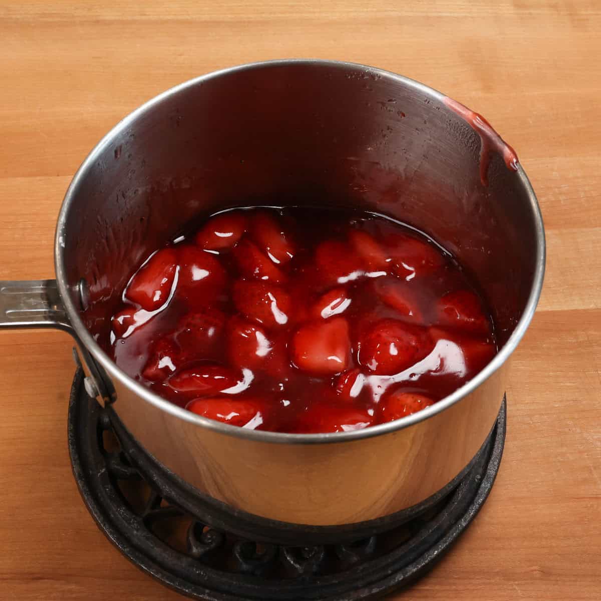 strawberry pie filling in a saucepan.