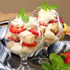 two trifles on a silver tray next to a blue napkin.